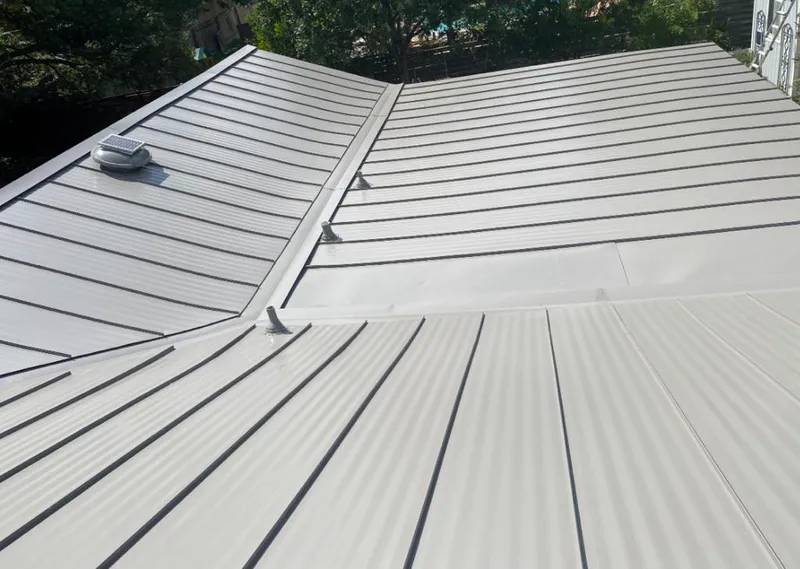Solar attic fan installed on a metal roof for Roof Ventilation in Sawmills